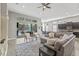 Open-concept living area with a modern kitchen, comfortable seating, and seamless outdoor access at 7114 Bowspirit Pl, Apollo Beach, FL 33572