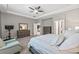 Spacious primary bedroom with tray ceiling, ceiling fan, sitting area, and ensuite bathroom at 7114 Bowspirit Pl, Apollo Beach, FL 33572