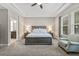 Bright main bedroom features a king bed, ceiling fan, tray ceiling, and ensuite bath at 7114 Bowspirit Pl, Apollo Beach, FL 33572