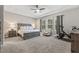 The main bedroom boasts a ceiling fan, many windows, and space for exercise equipment at 7114 Bowspirit Pl, Apollo Beach, FL 33572