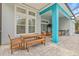 The patio shows a large table with seating and a grill area outside the home's big window at 7114 Bowspirit Pl, Apollo Beach, FL 33572