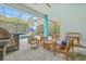 Screened patio featuring pavers, a built-in grill, and ample seating around the pool and lush tropical foliage at 7114 Bowspirit Pl, Apollo Beach, FL 33572
