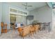A covered patio boasts comfortable seating, a television, and an outdoor kitchen for relaxation and entertainment at 7114 Bowspirit Pl, Apollo Beach, FL 33572