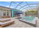 The pool deck features loungers, an umbrella, and a spa for relaxation and enjoyment at 7114 Bowspirit Pl, Apollo Beach, FL 33572