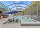 The in-ground pool features an in-water bar and spa area, set under a screened enclosure at 7114 Bowspirit Pl, Apollo Beach, FL 33572