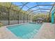 A luxurious screened in pool and spa offer relaxation and recreation surrounded by tropical landscaping at 7114 Bowspirit Pl, Apollo Beach, FL 33572