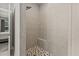 Walk-in shower with tile surround, built-in bench, and a modern shower head at 7114 Bowspirit Pl, Apollo Beach, FL 33572