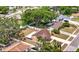 An aerial view showing the fenced backyard, mature trees, and a sunroom addition on this cozy single-Gathering home at 7206 Timber Ct, Tampa, FL 33625