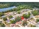 Aerial view of a lakeside home with mature trees and neighborhood streets at 7206 Timber Ct, Tampa, FL 33625