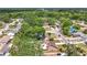 Presents an aerial view of a residential area with mature trees and neatly arranged houses at 7206 Timber Ct, Tampa, FL 33625