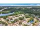 Scenic aerial view of a residential neighborhood nestled among lush trees and a serene lake at 7206 Timber Ct, Tampa, FL 33625