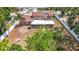 Aerial view of property showing a large, fenced yard, mature trees, and a screened-in patio, offering privacy and outdoor space at 7206 Timber Ct, Tampa, FL 33625
