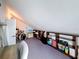 View of an attic area with a mix of carpeting and storage shelves, maximizing space under sloped ceilings at 7206 Timber Ct, Tampa, FL 33625