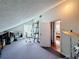A carpeted attic space offering versatility as a home office or creative area, with bright natural light at 7206 Timber Ct, Tampa, FL 33625