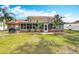 Expansive backyard featuring a screened lanai, lush lawn, and mature landscaping providing a private outdoor oasis at 7206 Timber Ct, Tampa, FL 33625