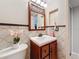Small bathroom with tiled walls and wooden vanity at 7206 Timber Ct, Tampa, FL 33625