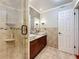 Modern bathroom featuring double sinks, granite countertops, and a spacious glass-enclosed shower at 7206 Timber Ct, Tampa, FL 33625
