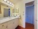 Well-lit bathroom featuring a white vanity, large mirror, and white cabinets at 7206 Timber Ct, Tampa, FL 33625