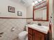 Small bathroom with tiled walls and wooden vanity at 7206 Timber Ct, Tampa, FL 33625