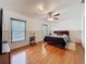 This bedroom features a ceiling fan, wood flooring and two windows at 7206 Timber Ct, Tampa, FL 33625