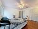 Bright bedroom with hardwood flooring, ceiling fan, and closet space at 7206 Timber Ct, Tampa, FL 33625