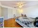 Bright bedroom featuring hardwood flooring, closet space, and a ceiling fan at 7206 Timber Ct, Tampa, FL 33625