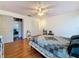 Bright bedroom with hardwood flooring, ceiling fan, and closet space at 7206 Timber Ct, Tampa, FL 33625