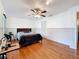 This bedroom features a ceiling fan, and wood flooring at 7206 Timber Ct, Tampa, FL 33625