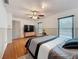 This bedroom features a ceiling fan, wood flooring, and a TV at 7206 Timber Ct, Tampa, FL 33625