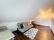 Attic bonus room with hardwood floors, a futon, and a comfortable chair at 7206 Timber Ct, Tampa, FL 33625