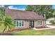 Charming single-story home with a well-maintained front yard and double door entry at 7206 Timber Ct, Tampa, FL 33625