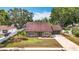 Charming single-story home with a well-maintained front yard, double door entry, and attached garage at 7206 Timber Ct, Tampa, FL 33625