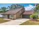 Charming single-story home with a well-maintained front yard and attached garage at 7206 Timber Ct, Tampa, FL 33625