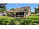 Beautiful home exterior featuring a screened-in patio and lush green lawn, perfect for outdoor living and entertaining at 7206 Timber Ct, Tampa, FL 33625