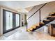 Welcoming foyer featuring a modern staircase and stylish front doors at 7206 Timber Ct, Tampa, FL 33625