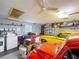Organized garage featuring laundry area, storage, and classic cars, blending utility with hobby space at 7206 Timber Ct, Tampa, FL 33625