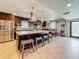 Open concept kitchen with granite island, stainless appliances, dining area, and tile floors at 7206 Timber Ct, Tampa, FL 33625