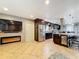 Open concept kitchen and living area with modern fireplace, stainless appliances, and granite countertops at 7206 Timber Ct, Tampa, FL 33625