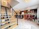Open-concept kitchen and dining area, featuring dark wood cabinetry, an island with seating, and contemporary lighting at 7206 Timber Ct, Tampa, FL 33625