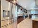 Spacious kitchen with stainless steel refrigerator, granite counters, pendant lighting, and dark wood cabinetry at 7206 Timber Ct, Tampa, FL 33625