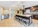 Open concept kitchen with a large island, breakfast bar seating, stainless steel appliances, and dark wood cabinetry at 7206 Timber Ct, Tampa, FL 33625