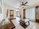 Inviting living room with tile flooring, elegant display cabinet, and decorative ceiling fan at 7206 Timber Ct, Tampa, FL 33625