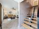 Stylish living room adjacent to a modern staircase, with neutral decor and tile flooring at 7206 Timber Ct, Tampa, FL 33625