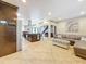 Open-concept living area with tile floors, modern staircase, kitchen and dining area with light-filled space at 7206 Timber Ct, Tampa, FL 33625