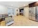 An open-concept living room with electric fireplace, television, and modern tile flooring at 7206 Timber Ct, Tampa, FL 33625
