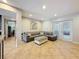 Bright living room with tile floors, recessed lighting, a gray leather couch and french doors to outdoor space at 7206 Timber Ct, Tampa, FL 33625