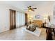 Comfortable living room featuring tile flooring, ceiling fan, and decorative curtains at 7206 Timber Ct, Tampa, FL 33625