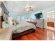 Spacious main bedroom with ceiling fan, ensuite bathroom and access to the yard through French doors at 7206 Timber Ct, Tampa, FL 33625
