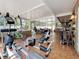 Bright sunroom with exercise equipment, kitchen access and lounge seating at 7206 Timber Ct, Tampa, FL 33625