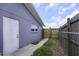 View of the home's backyard featuring chain-link fencing and a gate at 7625 Marechal Ave, Port Richey, FL 34668
